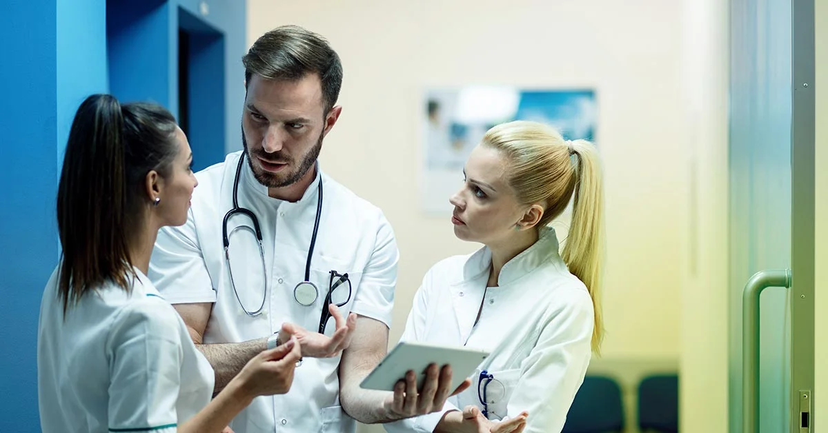 Clinical trial doctors and nurses discussing patient care during a study.