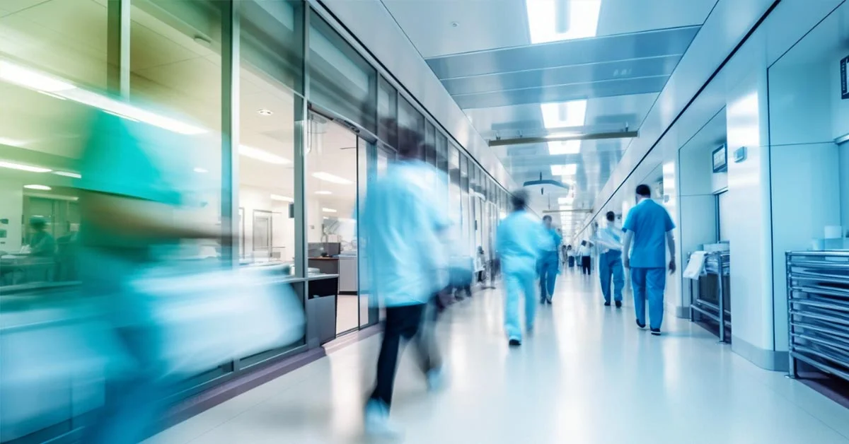 Medical professionals walking through hospital corridor—symbolizing the urgency and complexity of patient recruitment in clinical trials.